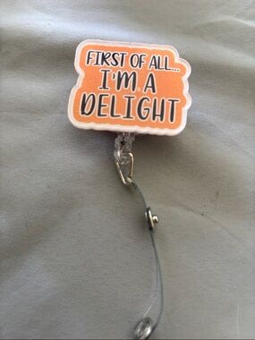 "First of All... I'm a Delight" Orange Badge Reel